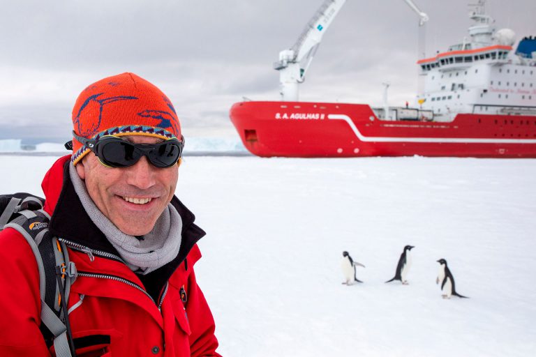 Dr John Shears with Adelie penguins beside Agulhas II | Endurance22