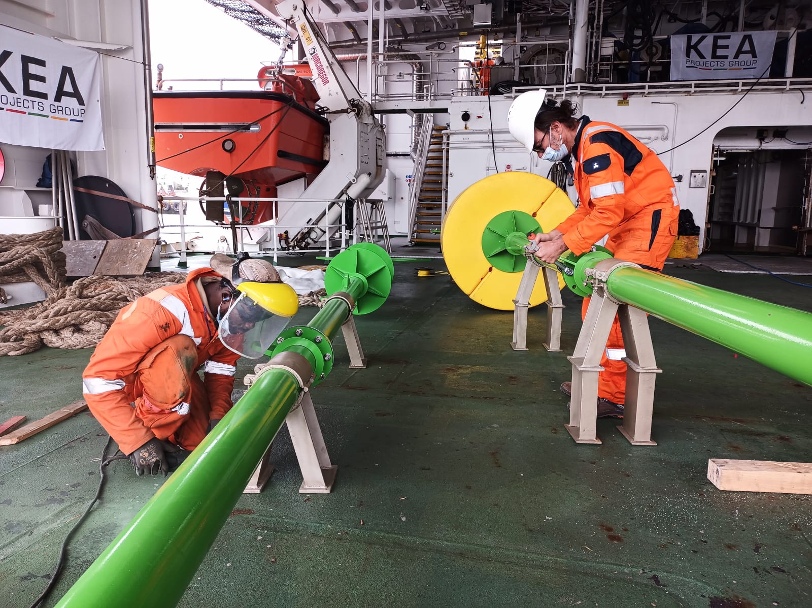 Engineers aboard Agulhas II prepare metal tubes called a "fish pole" used to protect the fiber optic cable of the Sabertooth underwater robots that will be used in searching for the Endurance - Endurance22